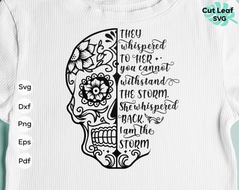May include: Black and white digital download of a sugar skull with floral designs. The skull is split in half with text on the right side that reads "They whispered to her you cannot withstand the storm. She whispered back. I am the storm."