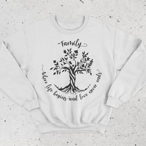 May include: White sweatshirt with a black tree design and the text "Family where life begins and love never ends".