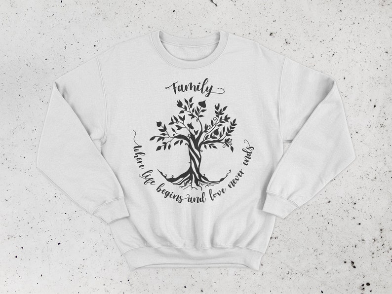 May include: White sweatshirt with a black tree design and the text "Family where life begins and love never ends".