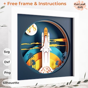 May include: A white framed papercraft with a 3D layered design of a space shuttle launching into a blue sky with a yellow moon and palm trees. The papercraft is in a white frame with the words "Free frame & Instructions" and "Cut Leaf SVG" on the top.