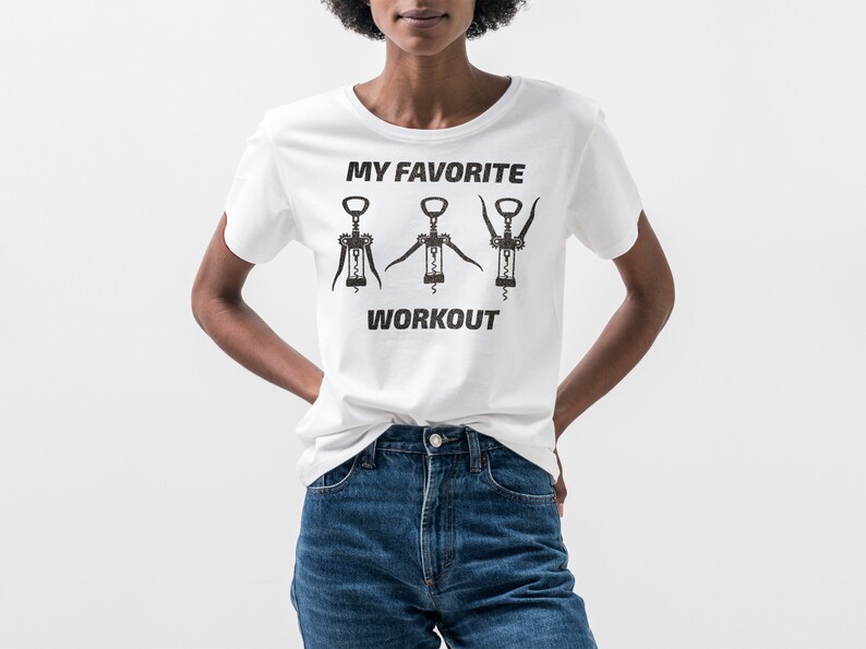May include: White t-shirt with a graphic of three corkscrews and the text "My Favorite Workout".