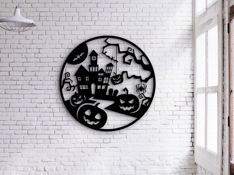 May include: Black metal Halloween wall art featuring a haunted house, jack-o'-lanterns, a spider, and a bat, all within a circular frame. The artwork is mounted on a white brick wall, creating a spooky seasonal decoration.