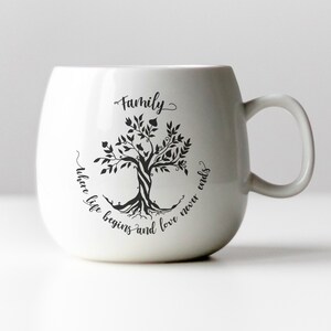 May include: White ceramic mug with a black tree design and the text "Family where life begins and love never ends".