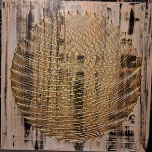 May include: Abstract wall art with a gold string art circle design on a textured, off-white and black painted background. The string art creates a layered effect, with gold thread contrasting against the neutral tones of the artwork.