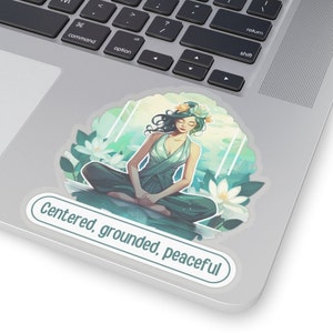 May include: A sticker featuring a woman meditating in a lotus pose with a flower crown. The background is a watercolor style with blue and green tones. The sticker has the text "Centered, grounded, peaceful" on the bottom.