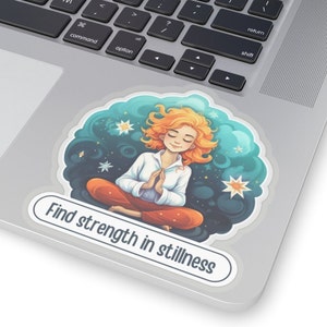 May include: A sticker with a cartoon illustration of a woman meditating in a starry sky. The text "Find strength in stillness" is written below the image.