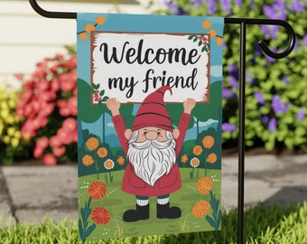 May include: A garden flag with a cartoon gnome holding a sign that says "Welcome my friend". The gnome is wearing a red hat and a red shirt. The background is a blue sky with green grass and flowers.