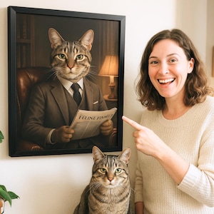 May include: A framed portrait of a cat dressed in a suit and tie, holding a newspaper that reads "Feline Financier". A person is pointing at the portrait, and a second cat is sitting in the foreground.