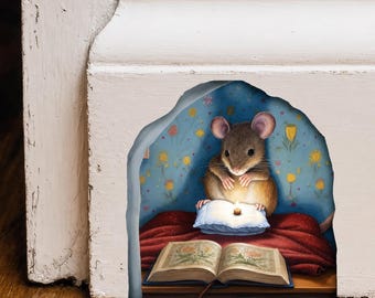 May include: A wall decal featuring a brown mouse sitting on a red blanket inside a blue floral room. The mouse is holding a small lit candle over a blue pillow, positioned behind an open book with botanical illustrations on the floor.
