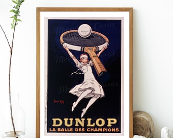 May include: Vintage poster advertising Dunlop tennis balls. A woman in a white dress is holding a tennis racket above her head with a Dunlop tennis ball on the strings. The poster is on a dark blue background with the text "DUNLOP LA BALLE DES CHAMPIONS" in white.