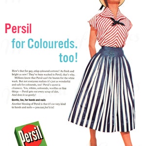 May include: Vintage advertisement for Persil laundry detergent. The image features a woman in a striped top and skirt, a straw hat, and white heels. The Persil box is green with red text. Text reads "Persil for Coloureds, too!"