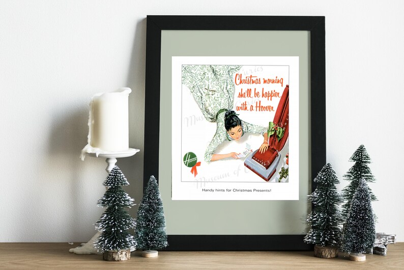 May include: A vintage advertisement for a Hoover vacuum cleaner. The ad features a woman in a floral dress, smiling as she looks at a red and silver Hoover vacuum cleaner. The text reads "Christmas morning she'll be happier with a Hoover. Handy hints for Christmas Presents!"