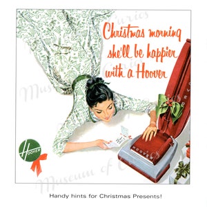 May include: A vintage advertisement for a Hoover vacuum cleaner. The ad features a woman in a white dress with green floral print, looking down at a red and silver Hoover vacuum cleaner. The text reads "Christmas morning she'll be happier with a Hoover".