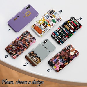 May include: Ten different phone case designs featuring various images and text from the popular TV show Friends. The designs include a purple case with a gold frame, a white case with a colourful collage of Friends-related images, a blue case with a collage of Friends-related text, a grey case with the word "Friends" in white, a collage of images from the show, a collage of images from the show, a collage of images from the show, a collage of images from the show, a collage of images from the show, and a collage of images from the show.