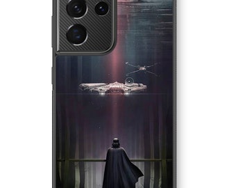 May include: A black phone case with a dark background featuring a silhouette of Darth Vader standing in a forest with a spaceship flying overhead.