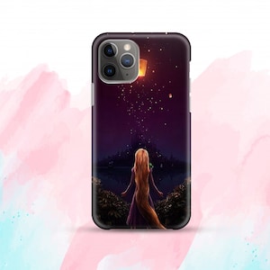 May include: A black phone case featuring a purple and black background image of a woman with long blonde hair standing in front of a castle with floating lanterns in the sky.