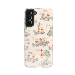 May include: A cream-coloured phone case with a Winnie the Pooh design. The case features a repeating pattern of Winnie the Pooh, Piglet, Eeyore, and Tigger characters in a whimsical floral setting.