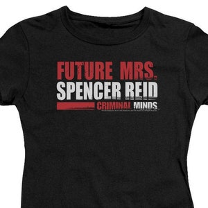 May include: Black t-shirt with red text that reads "Future Mrs. Spencer Reid" with the words "Criminal Minds" in smaller white text below.