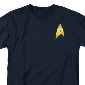 May include: A navy blue t-shirt with a gold Starfleet insignia on the front.
