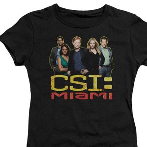 May include: Black t-shirt with a graphic of the cast of CSI: Miami. The text "CSI: Miami" is in yellow and red.