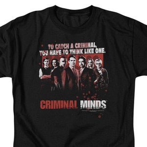 May include: Black t-shirt with a red and white graphic of the cast of the TV show "Criminal Minds". The graphic includes the text "To catch a criminal, you have to think like one." and "Criminal Minds".