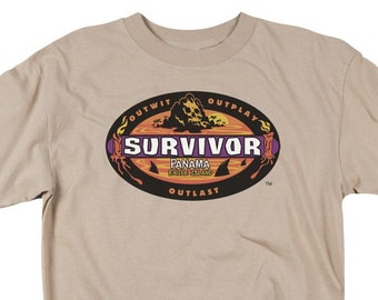 May include: A tan t-shirt with the Survivor logo printed on the front. The logo is a black oval with the word "Survivor" in white letters. The words "Outwit, Outplay, Outlast" are printed in a circle around the oval. The words "Panama - Exile Island" are printed in a smaller font below the oval.