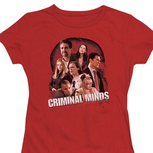 May include: Red t-shirt with a graphic of the cast of the TV show "Criminal Minds". The graphic features the main characters in a group shot with the show's title in white text.