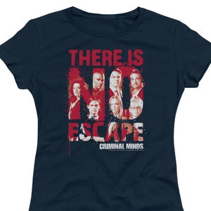 May include: A navy blue t-shirt with a red graphic of the Criminal Minds cast. The graphic says "There is No Escape" with the cast members' faces forming the letters. The text "Criminal Minds" is below the graphic.