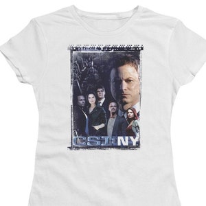 May include: White t-shirt with a graphic of the cast of CSI: NY. The graphic is in a distressed style and features the show's logo.