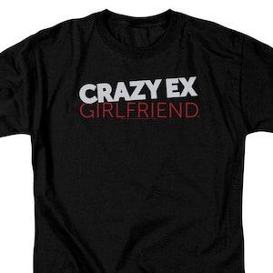 May include: Black t-shirt with white text that reads "CRAZY EX GIRLFRIEND."