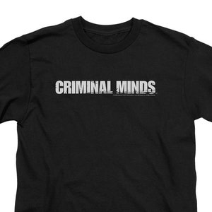 May include: Black t-shirt with the text "CRIMINAL MINDS" in white letters.