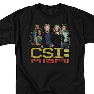 May include: Black t-shirt with a graphic of the cast of CSI: Miami. The text "CSI: MIAMI" is in yellow and red letters.