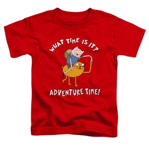 May include: Red t-shirt with a cartoon image of Finn and Jake from Adventure Time. The text "What time is it? Adventure Time!" is printed on the shirt.