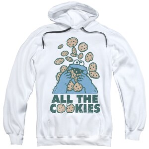 May include: White hooded sweatshirt with a blue Cookie Monster character eating cookies. The text "ALL THE COOKIES" is printed below the character.