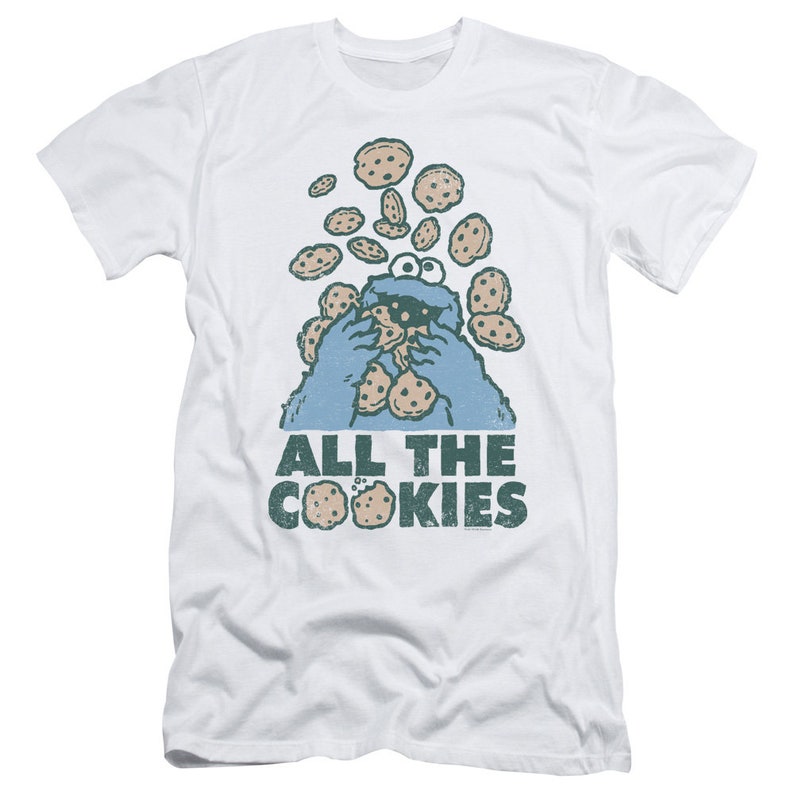 May include: White t-shirt with a blue Cookie Monster character eating cookies. The text "All the Cookies" is printed below the character.