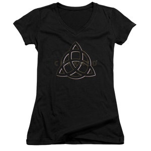 Op de afbeelding: Zwart V-hals T-shirt met een gouden en roze omtrek van het "Charmed" symbool, een driepuntige ster met een cirkel in het midden.