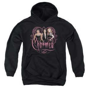 May include: Black hooded sweatshirt with a pink heart design featuring three women in black dresses and the text "Charmed" in pink.