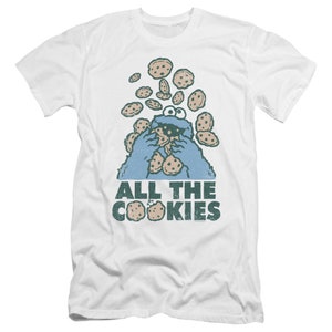 May include: White t-shirt with a blue Cookie Monster character eating cookies. The text "ALL THE COOKIES" is printed below the character.
