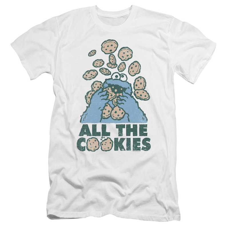 May include: White t-shirt with a blue Cookie Monster character eating cookies. The text "ALL THE COOKIES" is printed below the character.