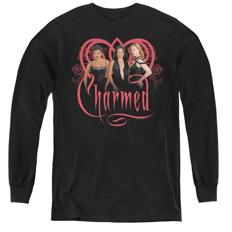 May include: Black long-sleeve t-shirt with a pink graphic of three women in black dresses standing in front of a pink heart with the word "Charmed" written in pink.