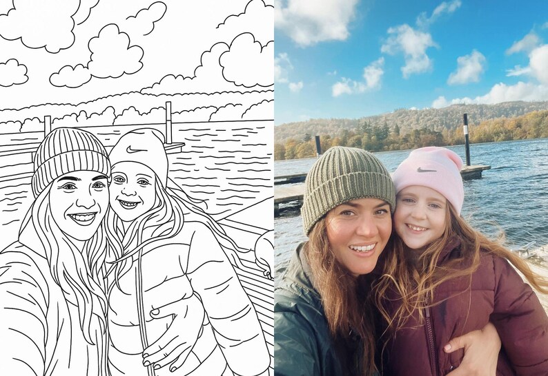 May include: Two people wearing knitted hats are smiling at the camera. The person on the left is wearing a grey hat and the person on the right is wearing a pink hat. They are standing in front of a body of water with a cloudy sky in the background.
