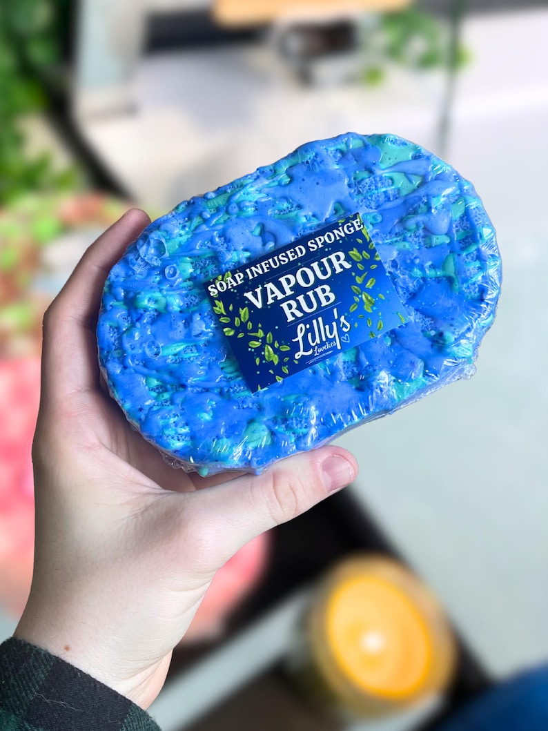 May include: A blue soap infused sponge with a label that reads "Soap Infused Sponge Vapour Rub Lilly's Lotions".