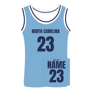 Puede incluir: Camiseta sin mangas azul claro con el texto "NORTH CAROLINA" y el n&uacute;mero "23" en azul marino. La vista trasera muestra el texto "NAME" y el n&uacute;mero "23". Ribetes blancos y azul marino acent&uacute;an el cuello y las sisas.
