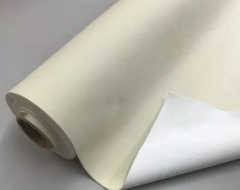 May include: A roll of white fabric with a smooth texture. The fabric is rolled up and the end is folded over to show the white underside.
