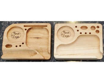 May include: Two wooden rolling trays featuring a "Your Logo" design. The tray on the left has a small compartment, a larger compartment, and a small groove. The tray on the right has a larger compartment and several small holes.