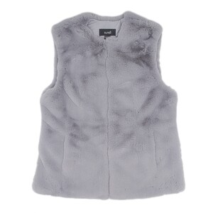 May include: A light gray faux fur vest with a soft, textured appearance. The vest has a simple, sleeveless design and a subtle sheen. The brand name "surell" is visible on a small tag at the neckline. This vest is a stylish outerwear option.
