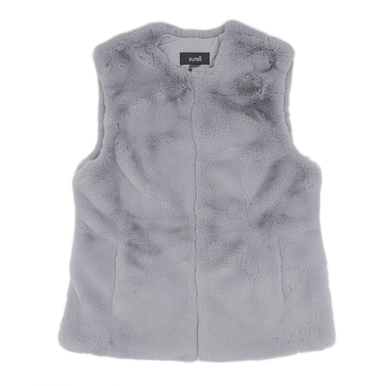 May include: A light gray faux fur vest with a soft, textured appearance. The vest has a simple, sleeveless design and a subtle sheen. The brand name "surell" is visible on a small tag at the neckline. This vest is a stylish outerwear option.