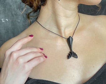 Ebony pendant black whale tail. Designer jewelry of exotic wood.