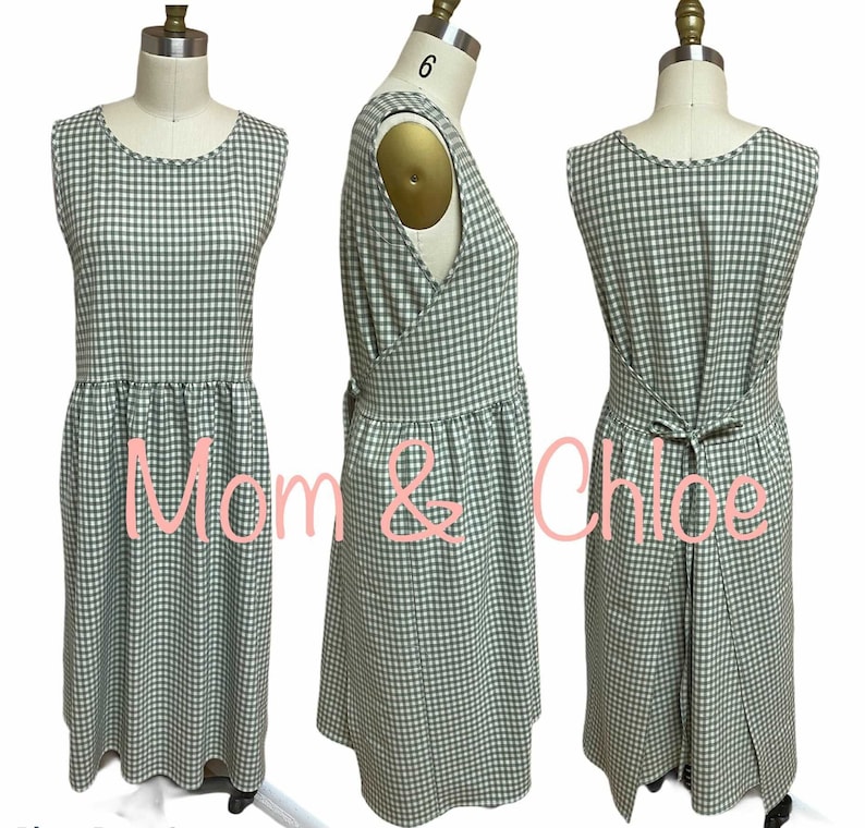 May include: A green and white gingham sleeveless dress with a gathered skirt and a tie at the back. The dress is on a mannequin.