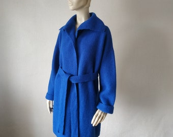 May include: A royal blue wool coat with a long sleeve, a collar, and a self-tie belt.